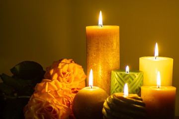 Six burning candles and roses, warm colors, feelings and memory, soft warm colors close up