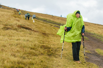 Woman with backpack hiking in the fog.