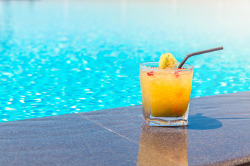 Yellow cocktail near the swimming pool