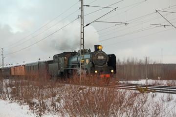 KOUVOLA, FINLAND - DECEMBER 26, 2018: Steam train Ukko-Pekka going from Kouvola to Kotka. The steam locomotive Hr1 1009 was made in 1948 and restored in 1993