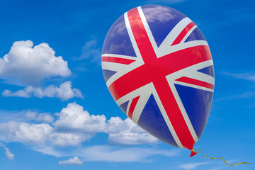 Balloon with the image of the national flag of UK flying against the blue sky. 3D rendering, illustration with a copy of the space.