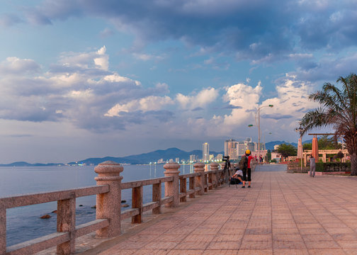 Vietnam, Nha Trang, May 6, 2015. Photographers on the waterfront taking pictures of the sunrise and cityscape