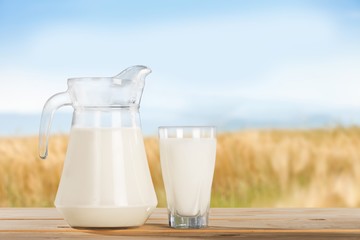 Obraz na płótnie Canvas Glass jug of fresh milk on background