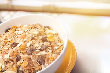 Bowl of  tasty corn flakes  on background