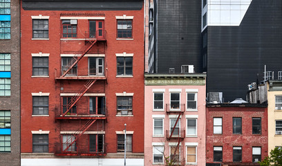 Old tenement houses with fire escapes in New York City, USA.