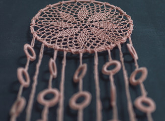 Dream catcher made on crochet - closup on dark background
