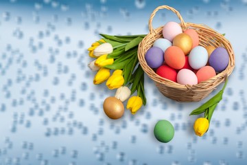 Easter basket filled with colorful eggs on a white background