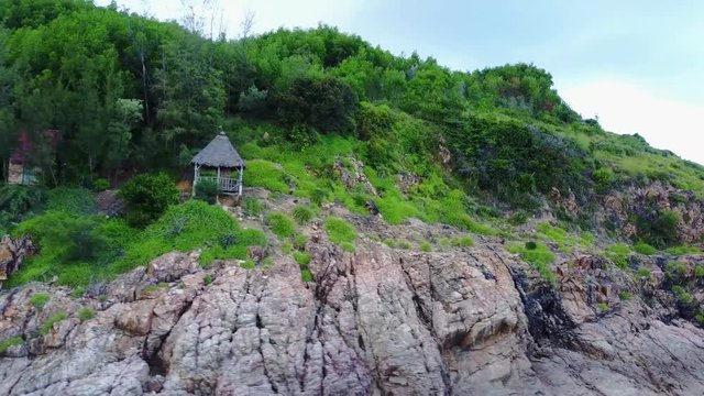 Small little self-built Houses next to high Cliffs - Asia