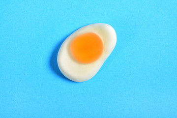 jelly candy fried egg over blue background