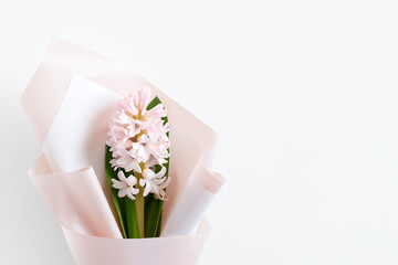 Spring flowers. Fresh bouquet with hyacinth in minimal style on light background. Top view, spring flat lay with copyspace for text. Love and gift concept