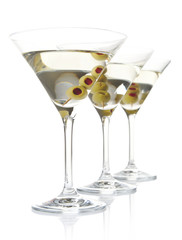 Three classic dry martini with olives isolated on white backgrou