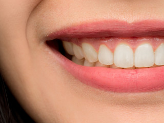 Closeup shot of Asian Chinese Thai woman female makeup face. Woman with red lips lipstick and healthy dental white great perfect teeth. Smiling, Dental dentist clinic concept. mouth open. Front teeth