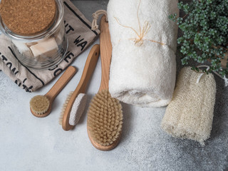 Zero waste concept. Eco-friendly bath set. Brushes, soap in jar, towel, pumice and bast and plant...