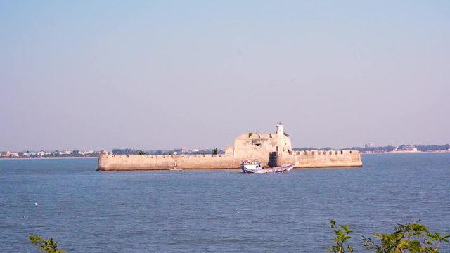Zoom aerial shot of the Pani Kotha prison in the middle of the sea as seen from Diu fort Gujarat India
