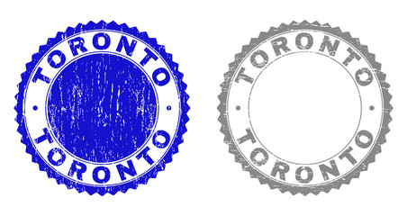 Grunge TORONTO watermarks isolated on a white background. Rosette seals with grunge texture in blue and grey colors. Vector rubber stamp imitation of TORONTO caption inside round rosette.
