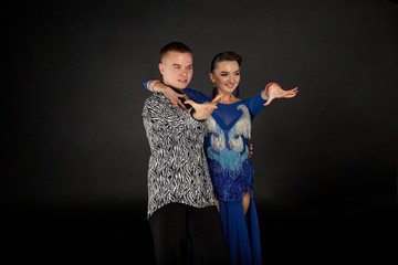 Happy couple dancing together, girl in blue dress