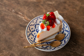 New York cheesecake topping cream and serve with cherries jam on a beautiful plate.