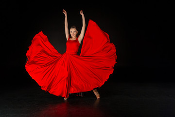 Studio shot of beautiful european girl in red dress