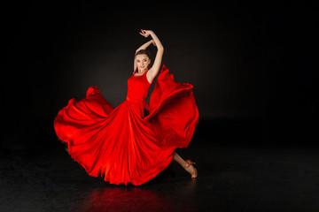 Studio shot of beautiful european girl in red dress