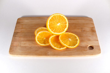 orange on cutting board isolated on white
