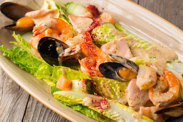 Seafood. Shrimp, mussels and salmon on a plate with salad