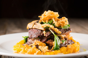 Grilled steak with mashed vegetables