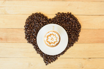hot cappuccino with nice milk pattern with coffee bean heart shape / coffee with love 