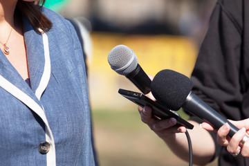 Reporters making media interview with business woman or female politician
