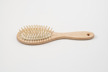 Wooden hair brush isolated on white background. Natural eco friendly hair brush.