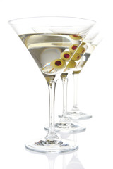 Three classic dry martini with olives isolated on white in a line