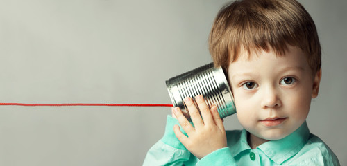 boy listen tin can telephone