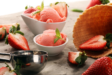 Strawberry ice cream scoop with fresh strawberries and icecream cones