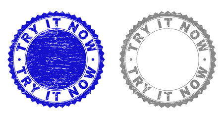 Grunge TRY IT NOW stamp seals isolated on a white background. Rosette seals with grunge texture in blue and gray colors. Vector rubber stamp imitation of TRY IT NOW tag inside round rosette.
