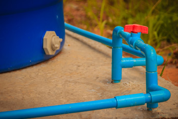 Naklejka premium Red knob of PVC ball valve on the PVC pipe line in plumbing system for control the water to storage tank.