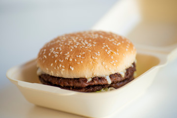 Hamburger take away meet and cheese fast food on container open