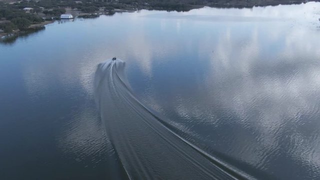 A boat motors along the shore of Brady Lake near Brady, Texas.