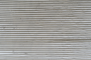 Obraz premium Parallel white lines with rusted paint of an old garage door suitable as background, aged metal