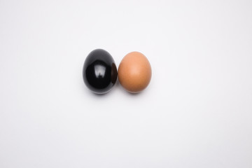 Black and brown egg on a white background close-up