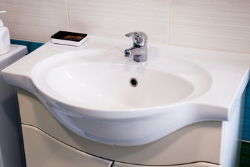 bathroom. white washbasin. the tap is closed. water does not flow.