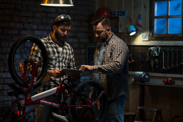 Fototapeta na wymiar Two mechanic talking in a workshop