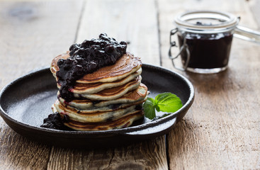 Stack of blueberry pancakes with homemede berry jam,  healthy breakfast