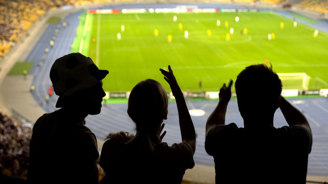 Frustrated young football fans arguing about game, disappointed by score, back - Powered by Adobe