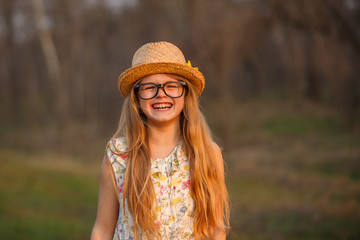 Portrait happy summer mood of joyful teen girl in glasses, braces and straw hat, having fun.expressing positivity, joy, happiness, smiling