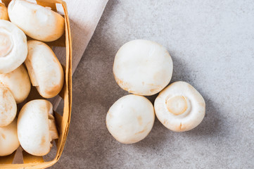 Organic fresh champignon on the table with basket.