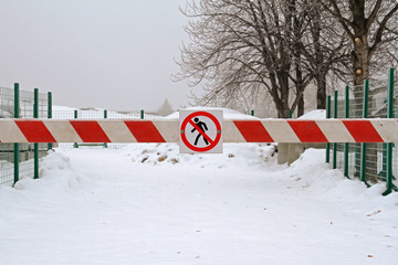 Sign "No entry" hanging on the barrier close-up