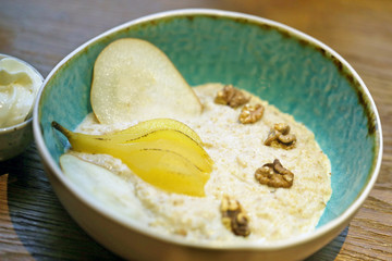 Oatmeal with pear and walnuts on almond milk