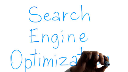 Manager writing search engine optimization phrase on white background, web site
