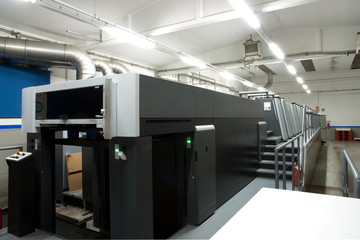 Press printing - Offset machine. Printing technique where the inked image is transferred from a...