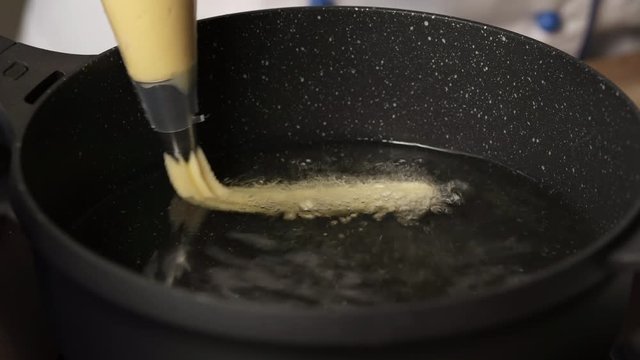 Cooking churos, dough churos on the pan
