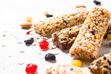 Granola bar with nuts, fruit and berries on white.